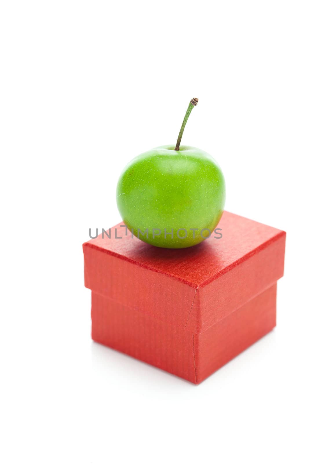 red gift box and green plum isolated on white by jannyjus