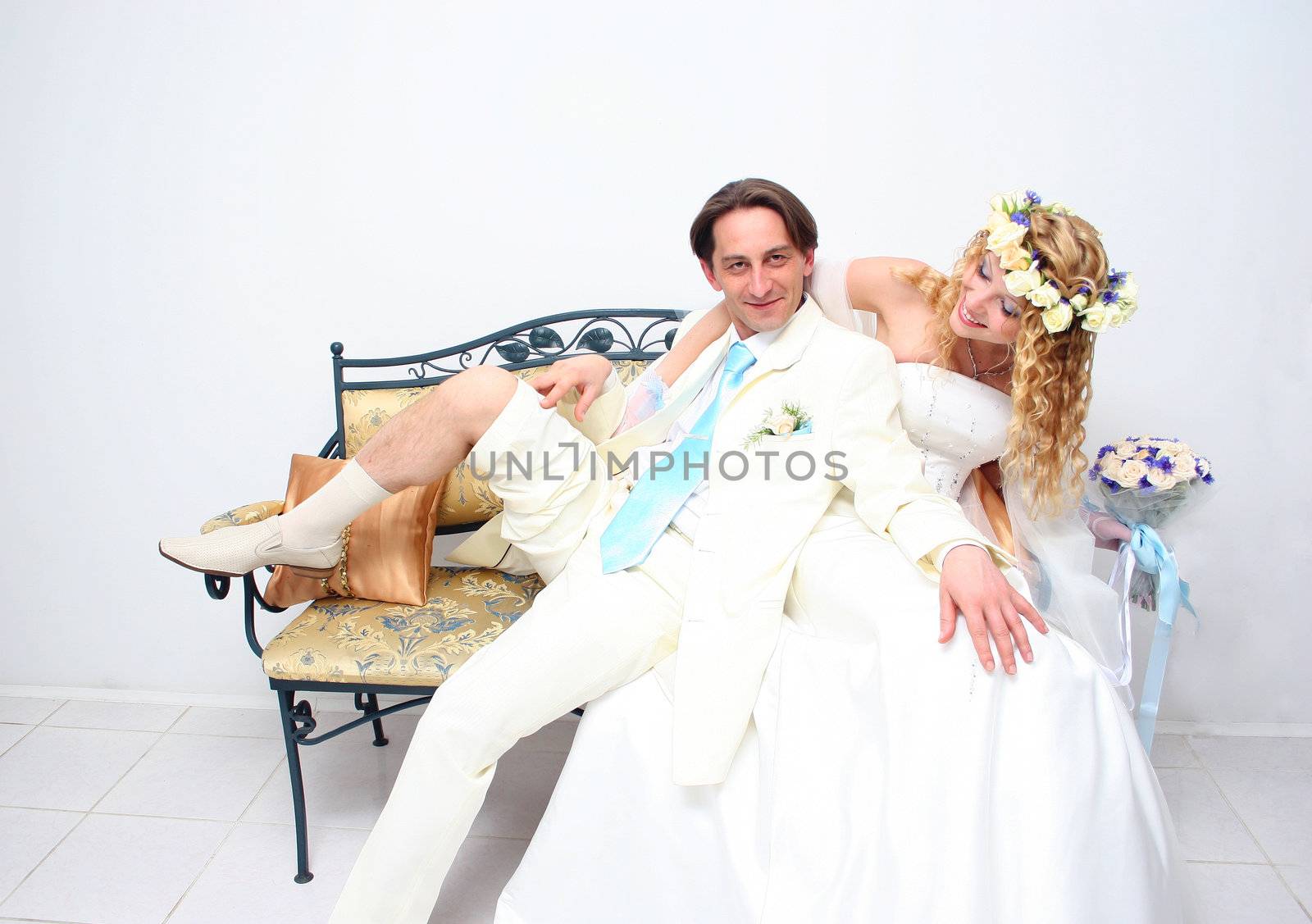 Young couple posing in a studio on the wedding day  by NickNick