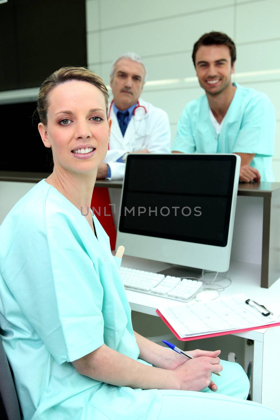 Medical colleagues with a computer and a blank screen by phovoir