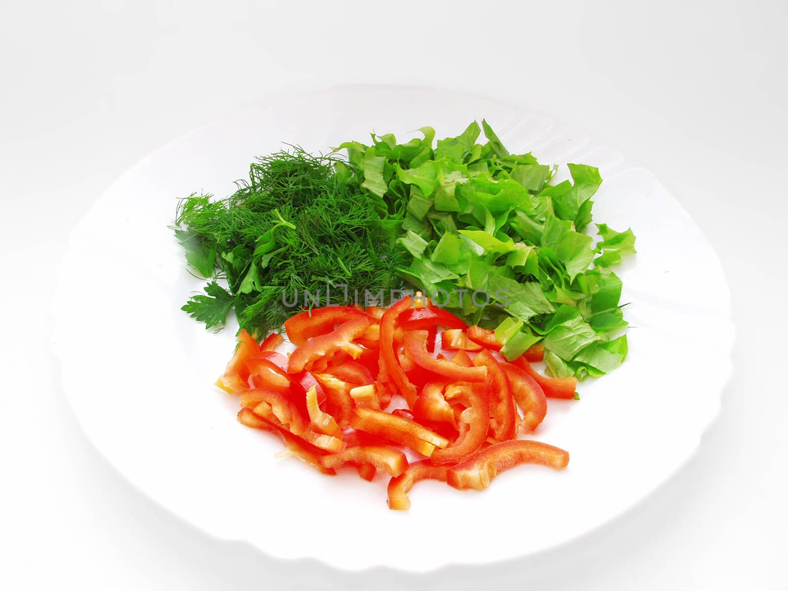 Plate with chopped lettuce, dill and slices of bell pepper by NickNick