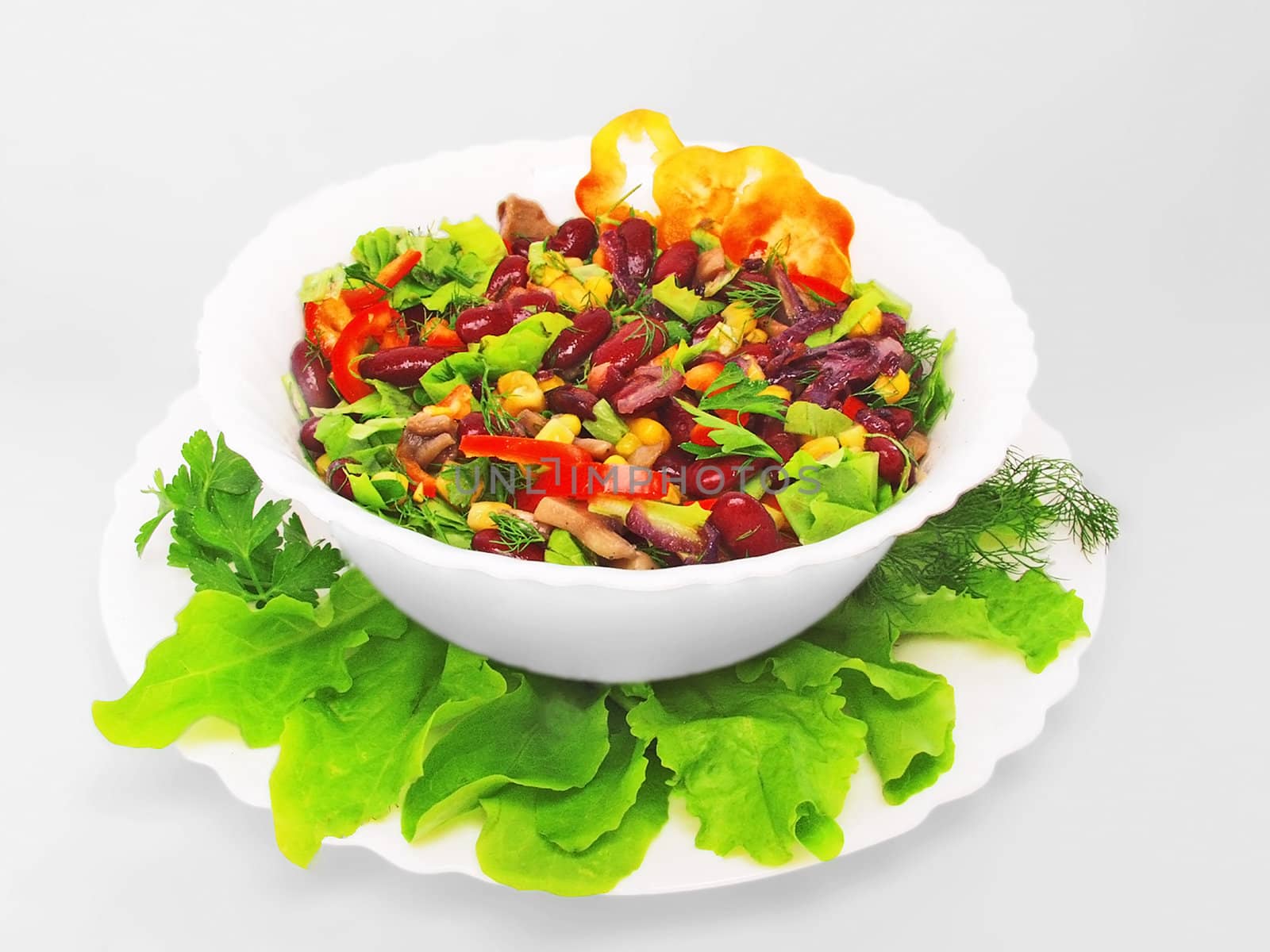 Vegetable salad in a plate on a white background