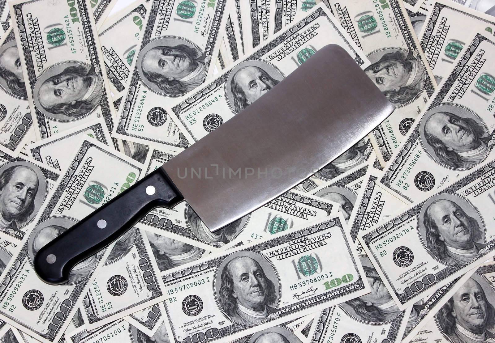 hatchet lying on the one hundred dollar bills