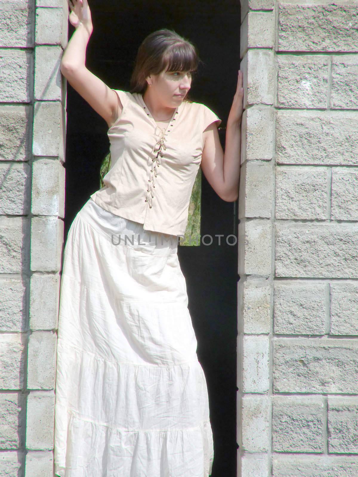 Young brunette girl walks in the park