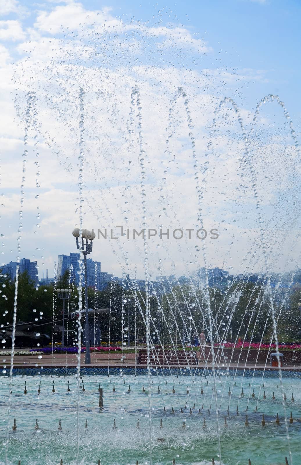 Fountain of pure brilliant water against a blue clear sky