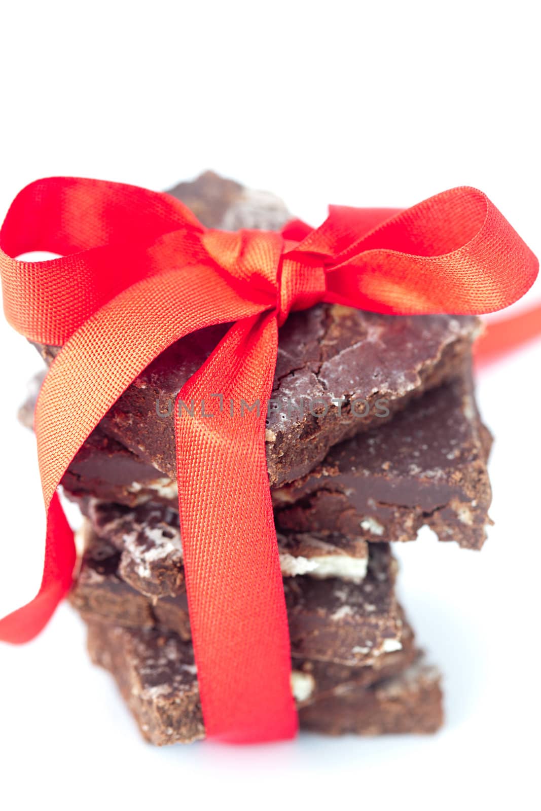 background of stack of chocolate with red ribbon