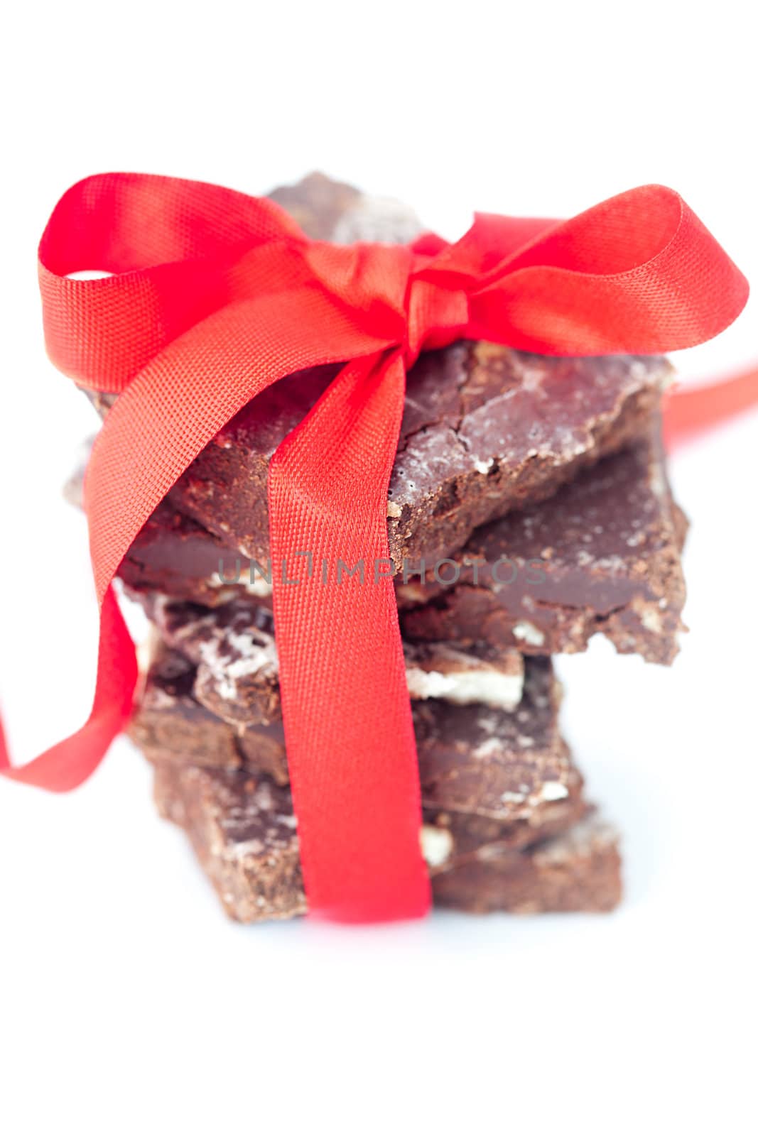 background of stack of chocolate with red ribbon by jannyjus