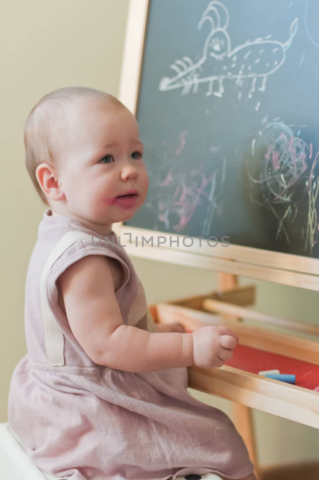Little girl paints on the board