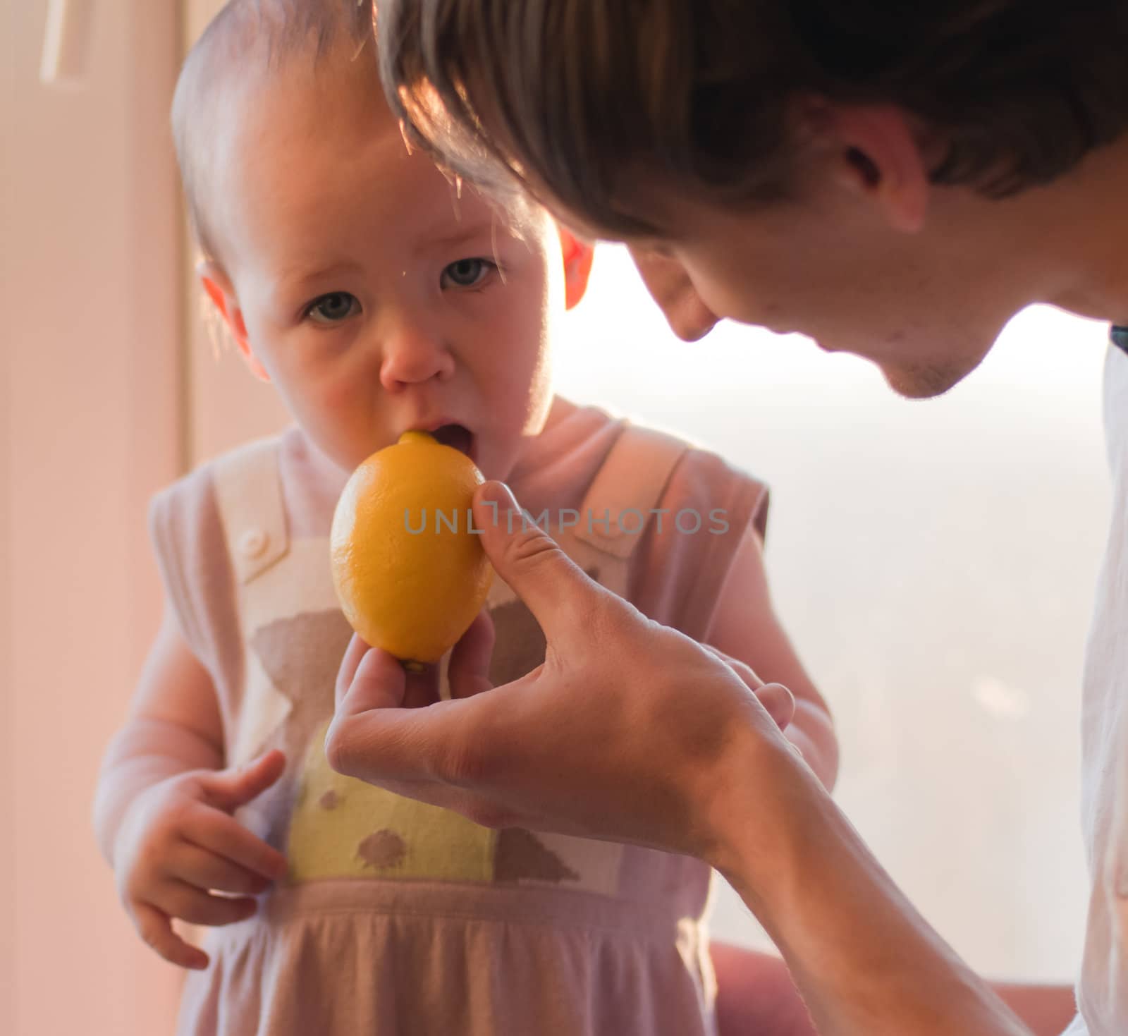 Father gives his daughter lemon