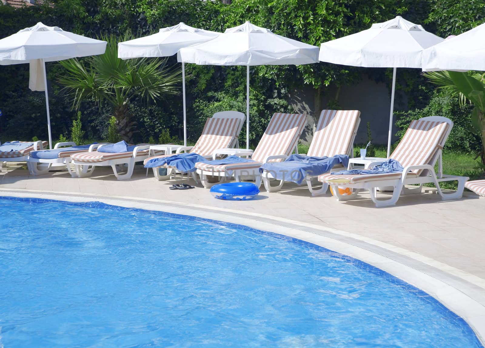 tourist resort with pool and white parasols