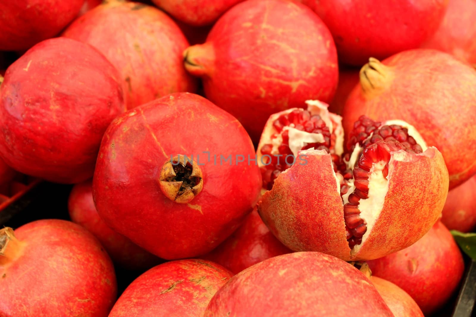 Agricultural background, a pile of beautiful pomegranates