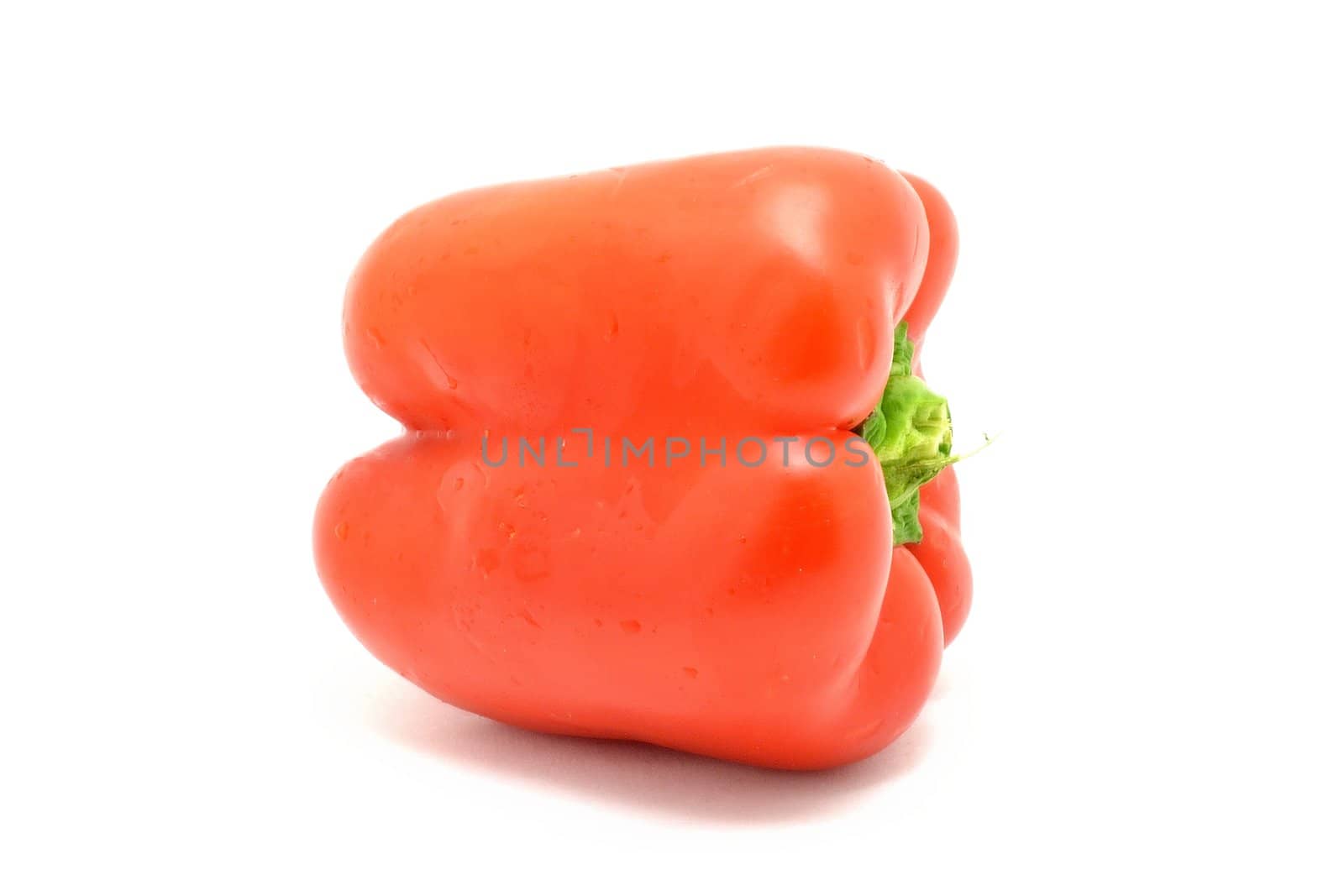 Fresh red pepper with waterdrops over white