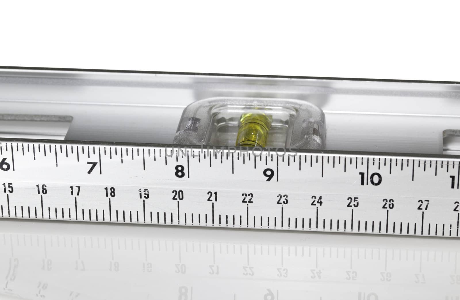Yellow spirit level in aluminum measuring ruler in inches and cm