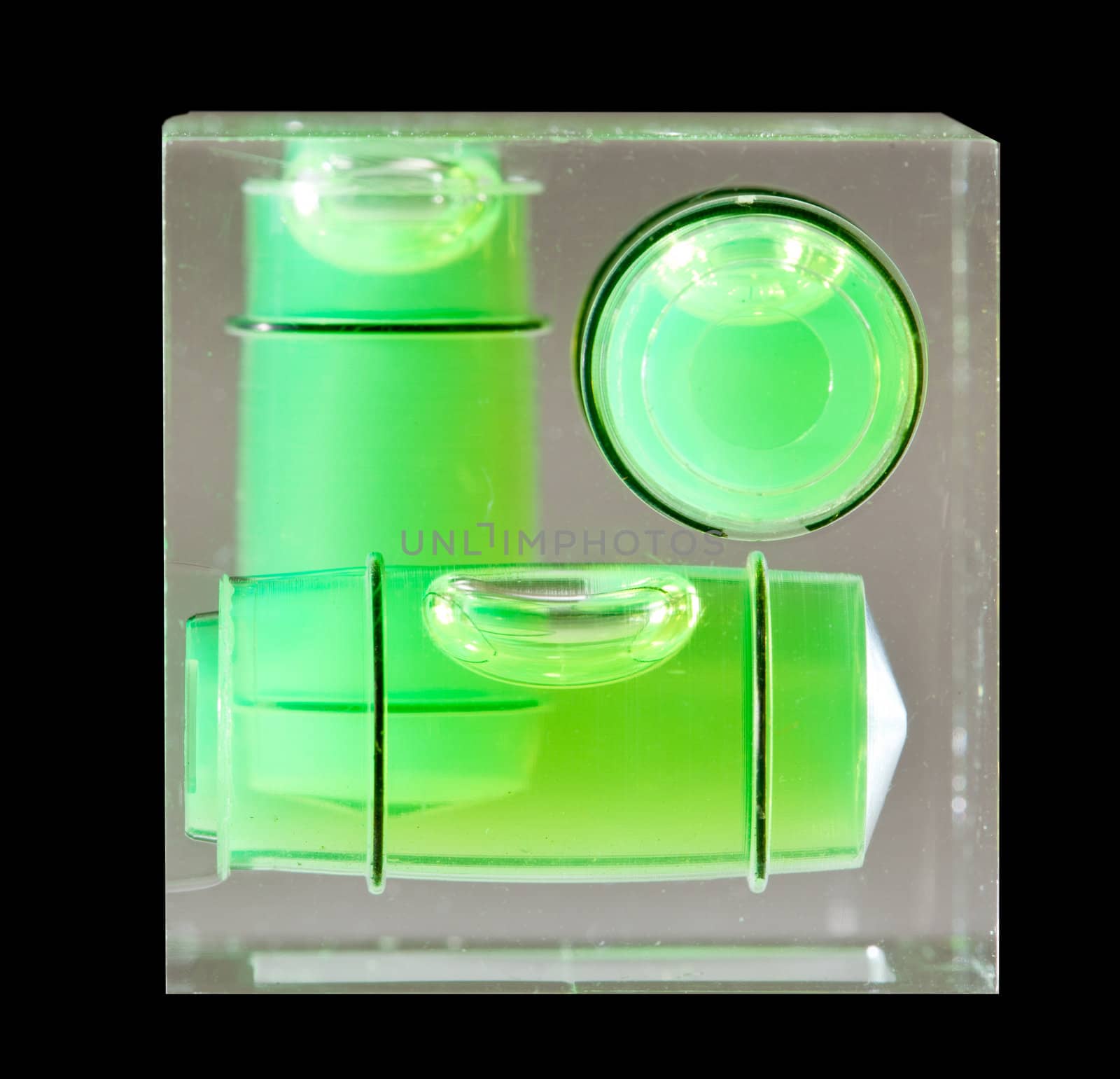 Three green spirit levels in plastic cube setting angle in any direction