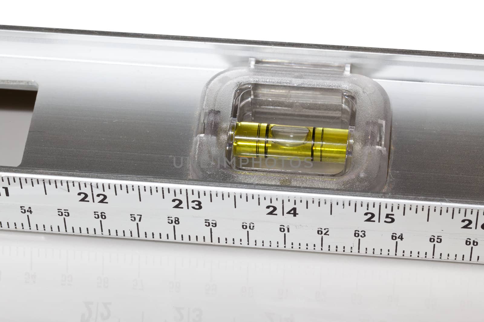 Yellow spirit level in aluminum measuring ruler in inches and cm