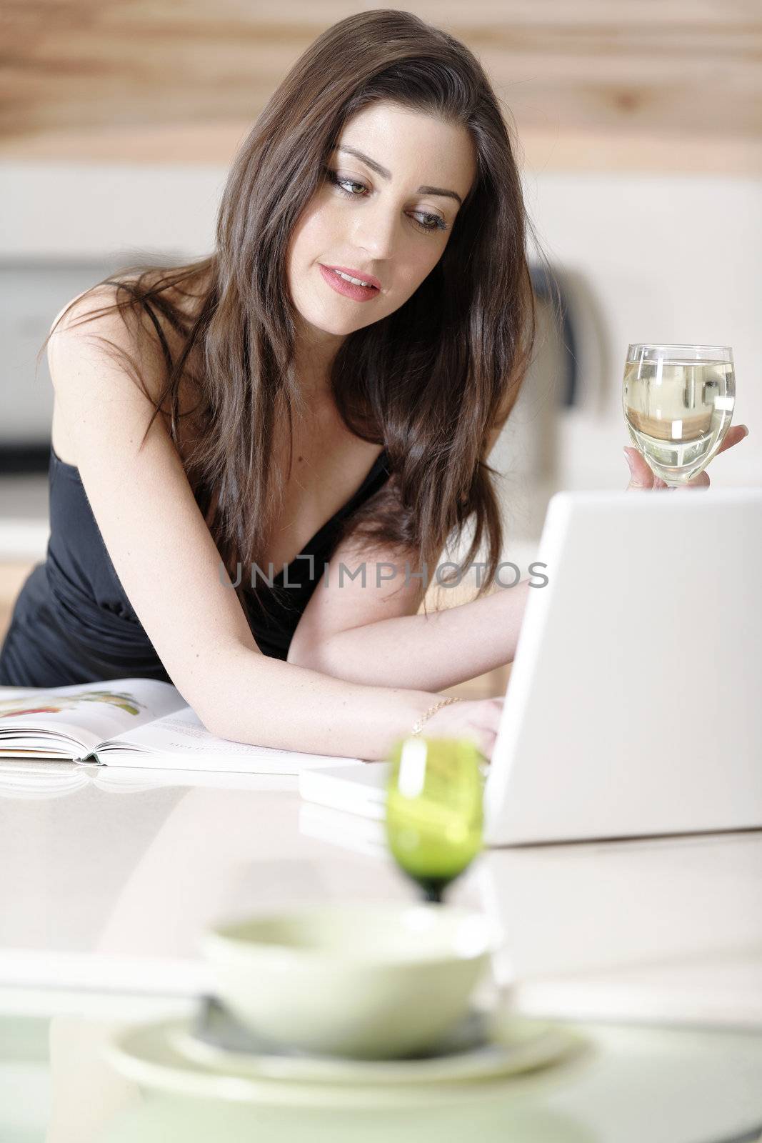 Woman reading recipe book by studiofi