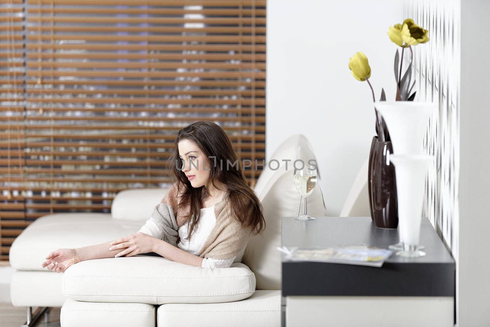 Beautiful woman relaxing in her elegant living room.