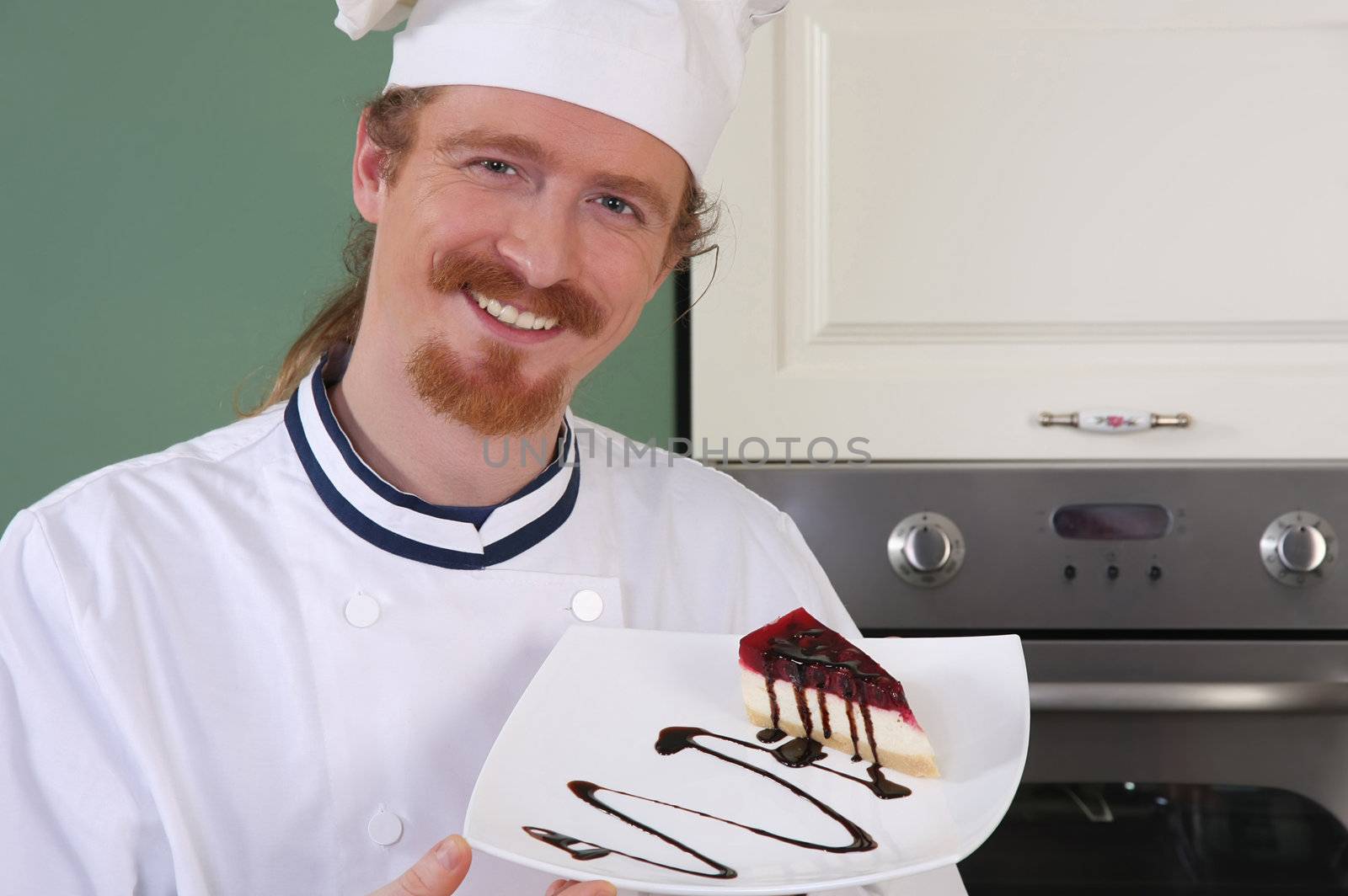 Young chef with piece of cake with chocolate sauce