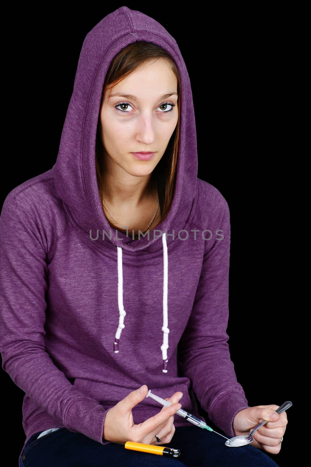 Young woman with syringe and drugs over black by Mirage3