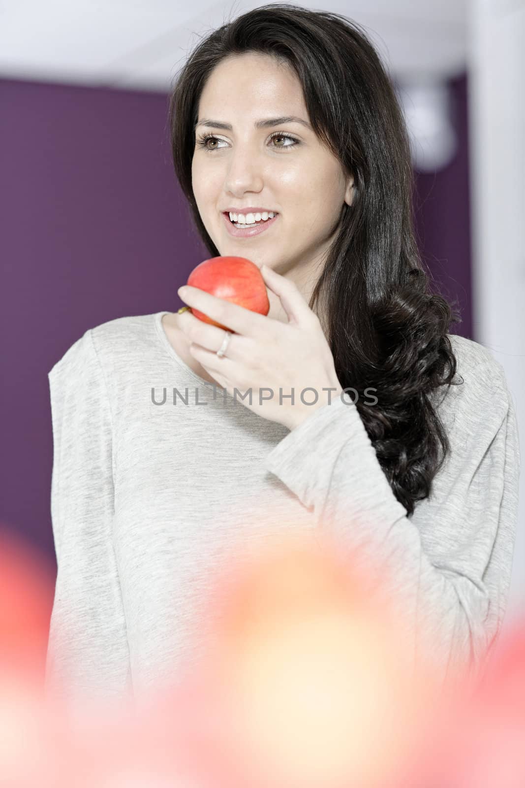 Woman holding an apple by studiofi