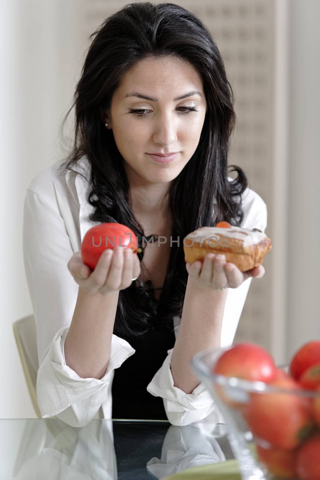 Woman choosing cake or fruit by studiofi