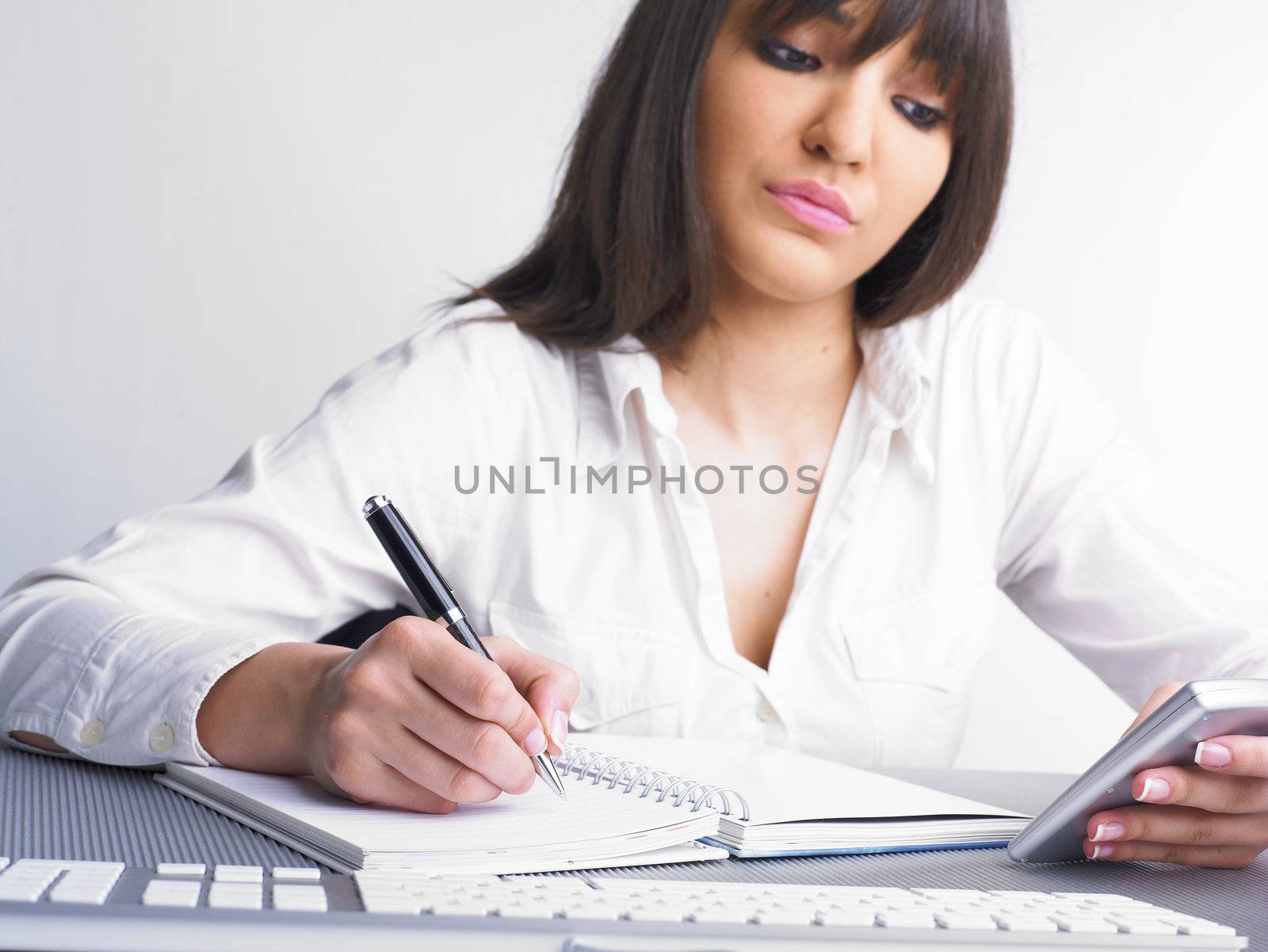 Office Assistant in white writing Schedule