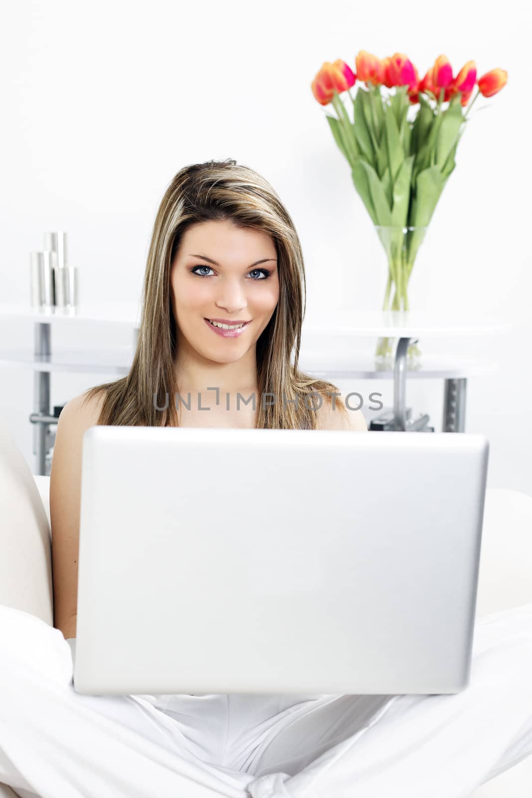 beautiful woman resting on sofa with laptop