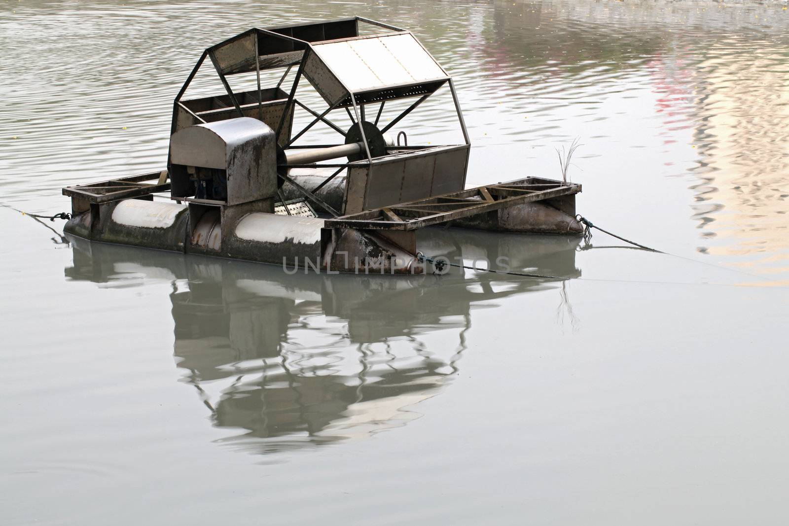 Metal wheel of watermill in Pond use for Add Oxygen for Industrial Sewerage System and water Treatment