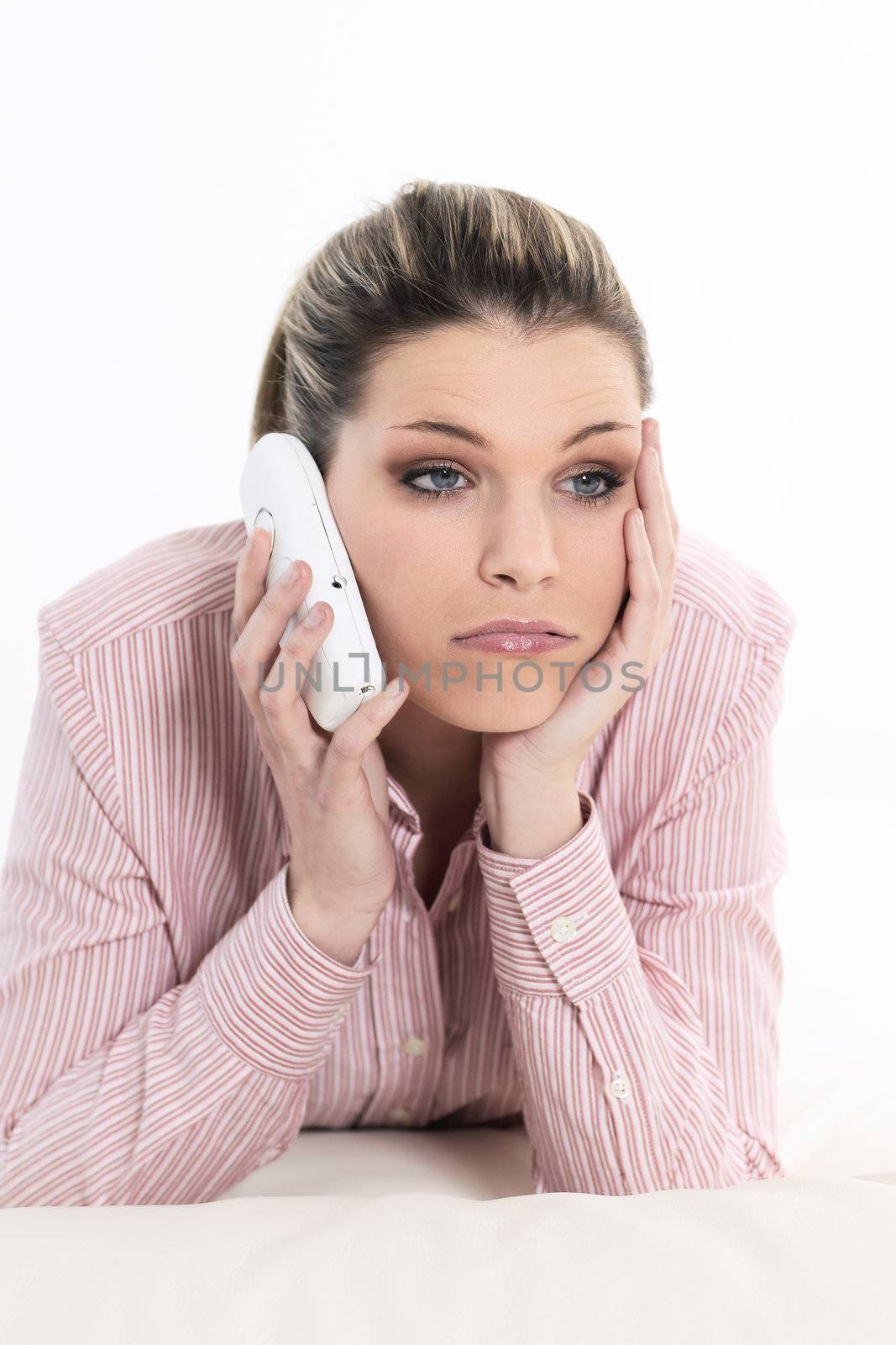 Upset, sad and worried by problems young woman talking by the phone.