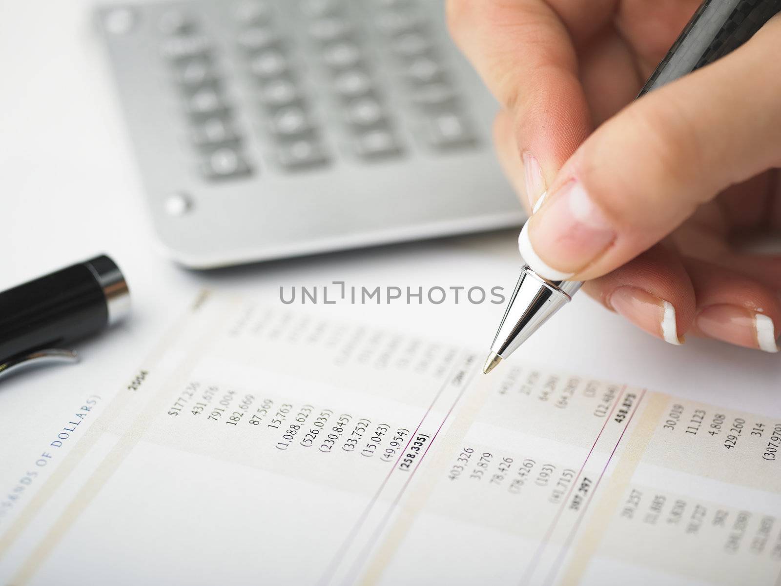 Market Analyze - pen and calculator on papers