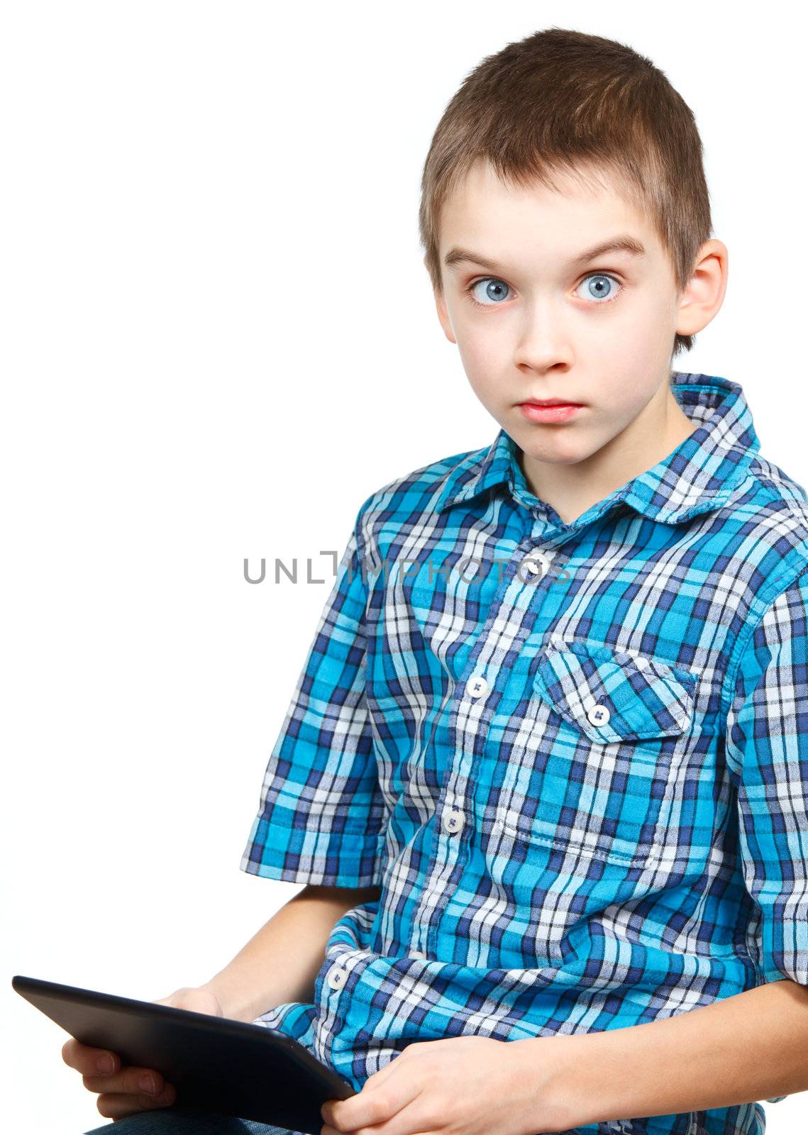 Portrait of 10 years boy wearing blue shirt holding a touch pad