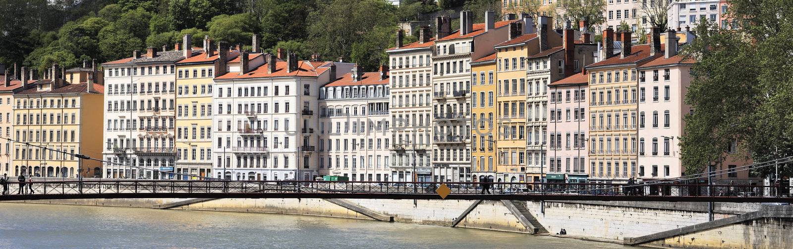 footbridge and series of colorful buildings in Lyon city