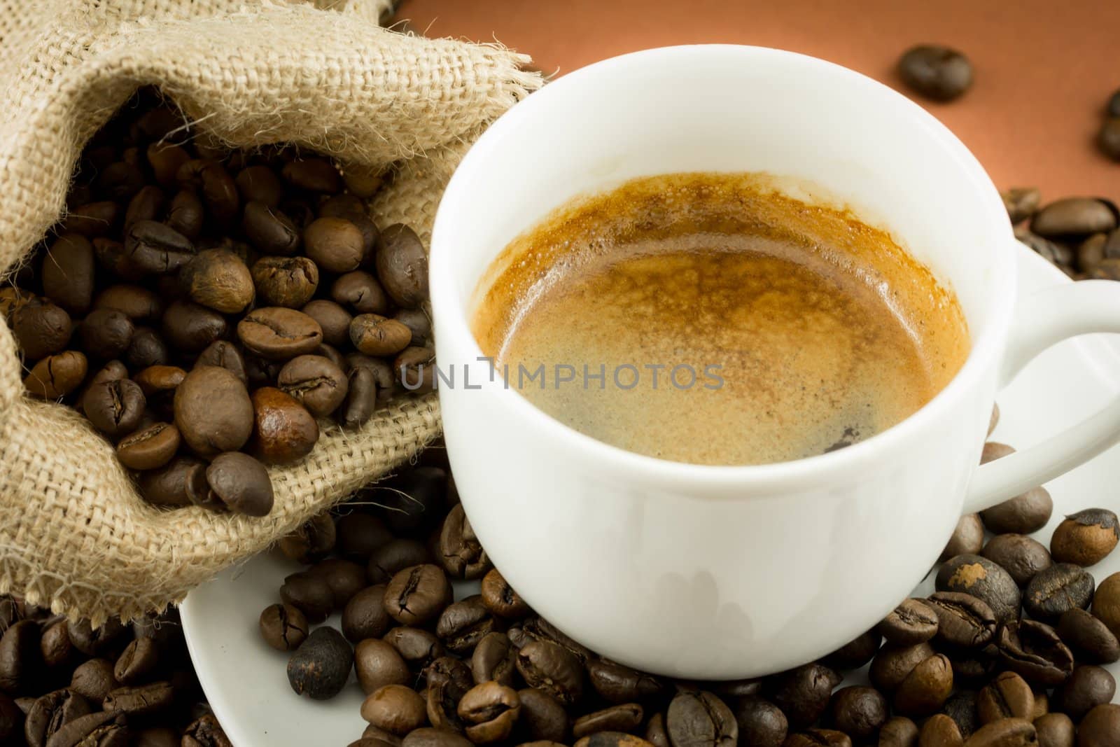 Coffee beans in a juta bag and cup