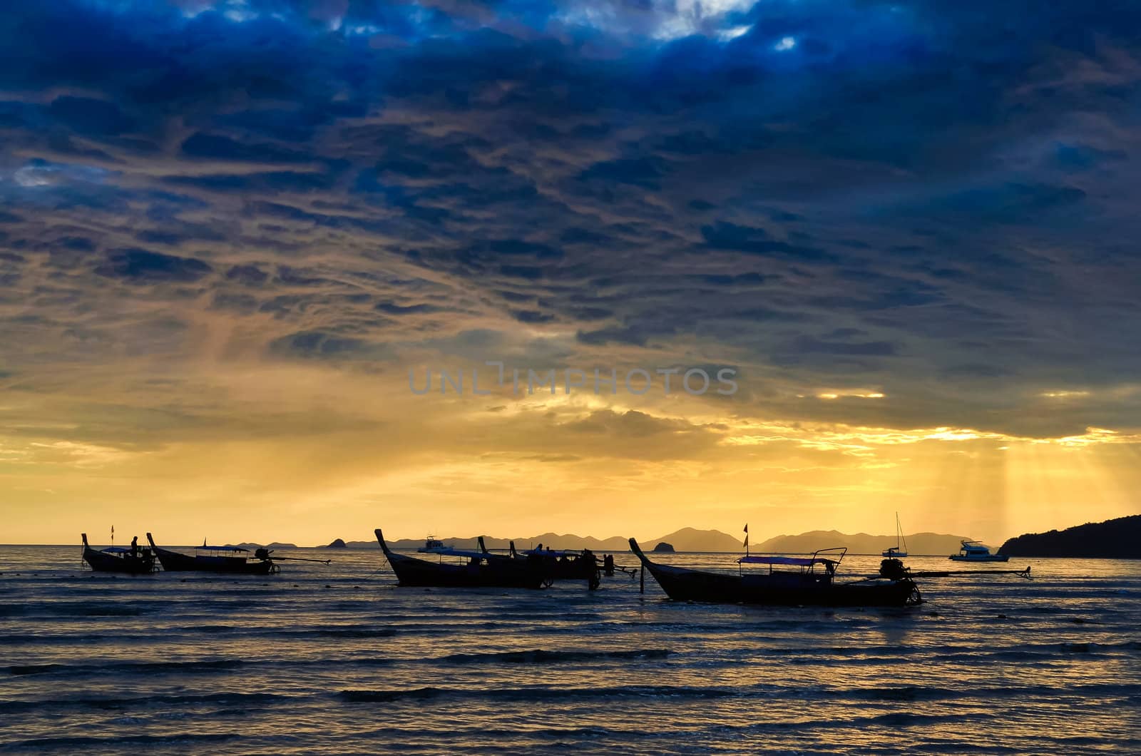 Ocean coast cloudy colorful sunset and fishing boats