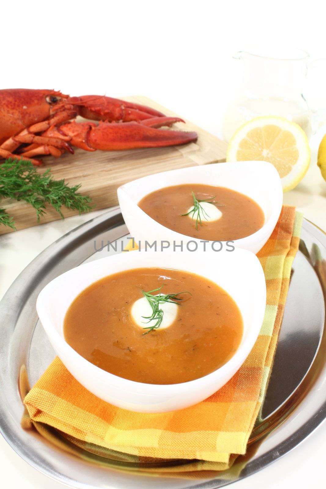 freshly cooked lobster soup with lemon, dill and cream dollop