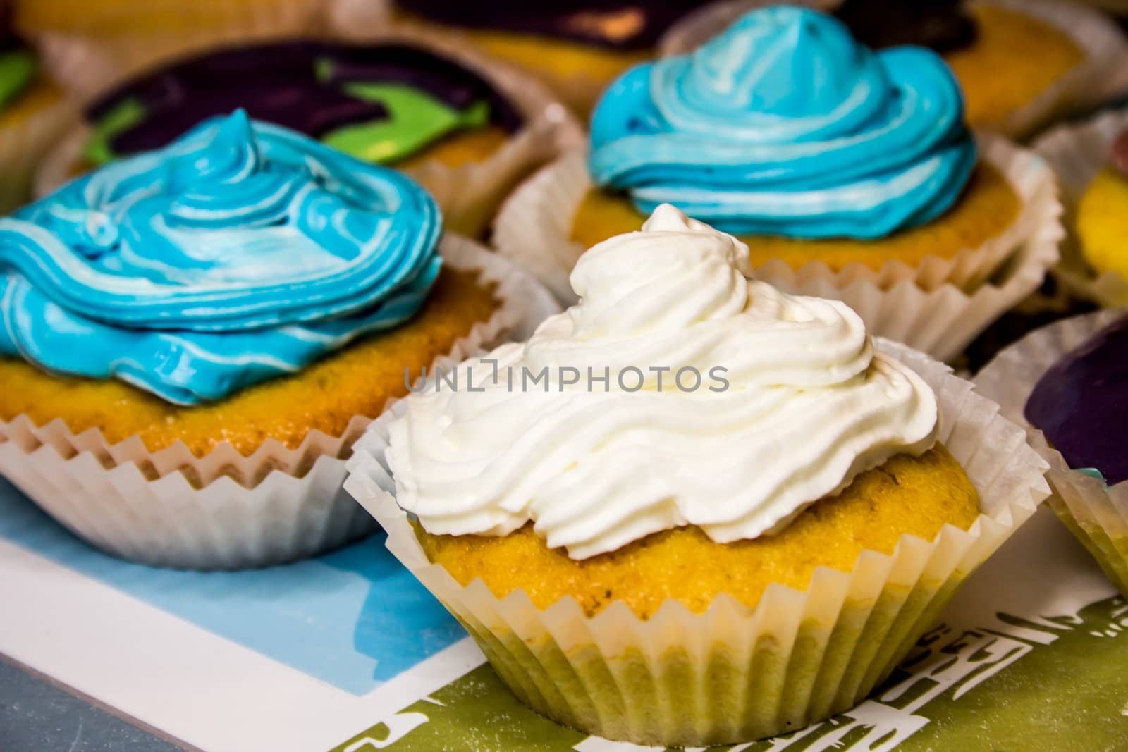 Some colored cupcakes with cream