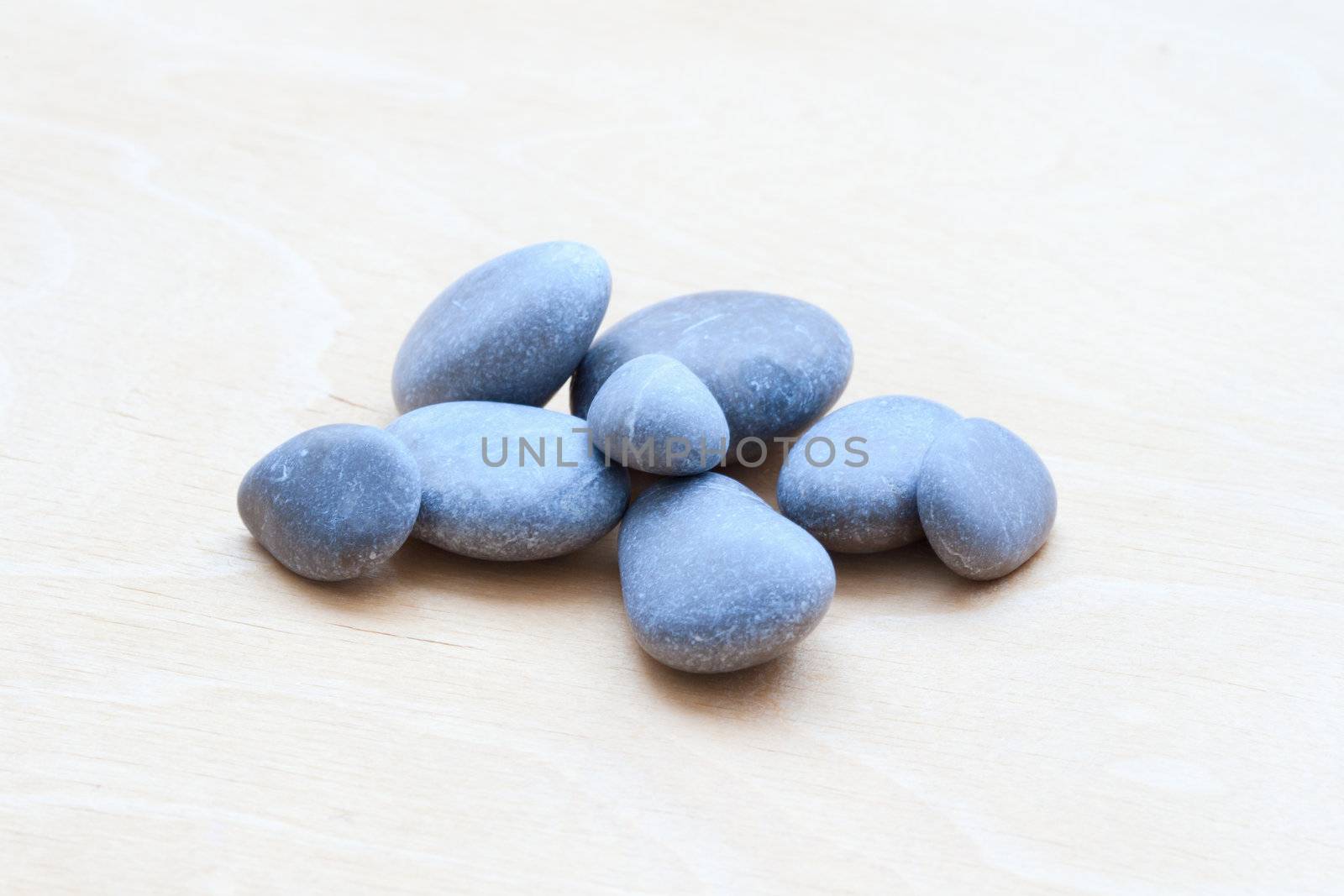 Smooth river rocks on a white wooden background