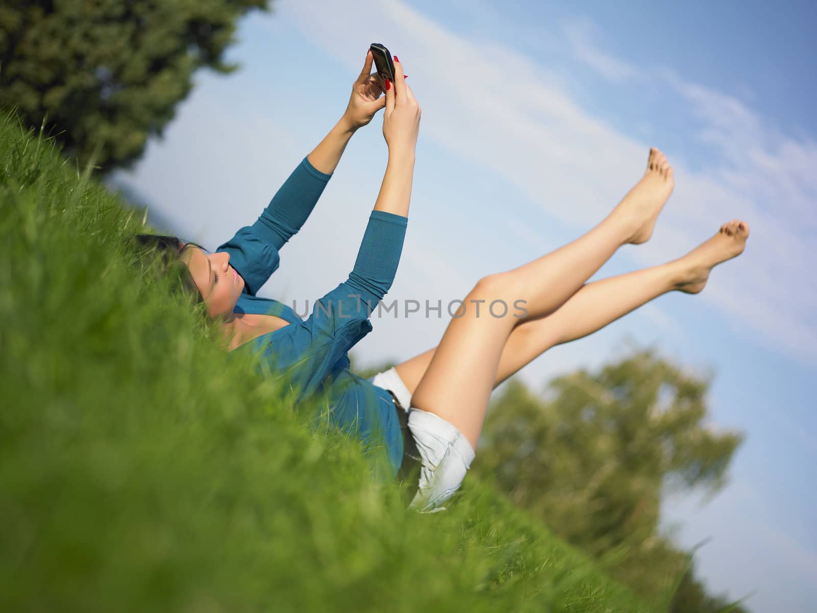 Young woman using laptop in park