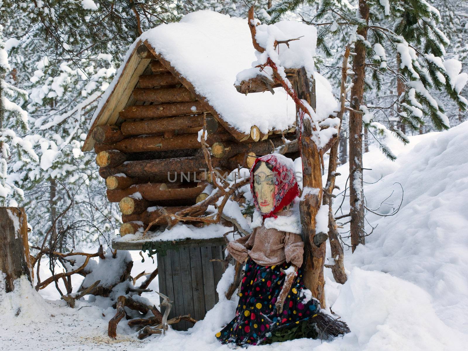Decorative cabin in the woods. Baba Yaga fairy tale character. Winter landscape.