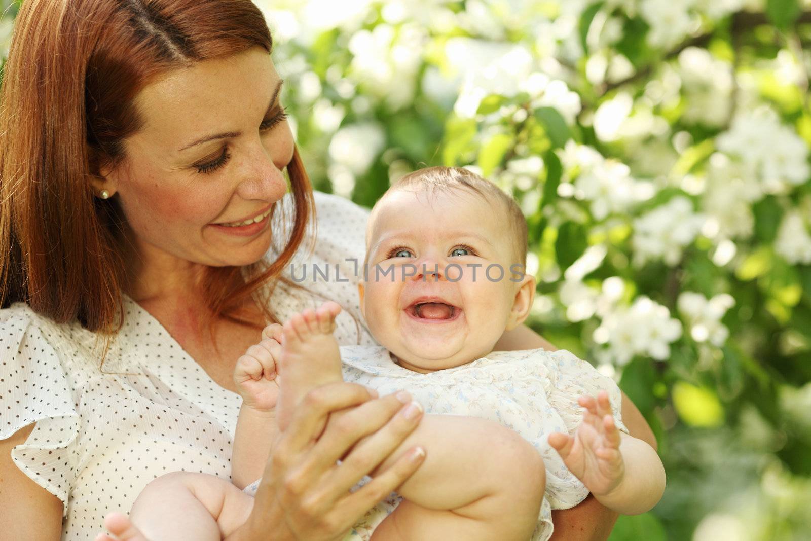 Mother and daughter close up portrait on flower background