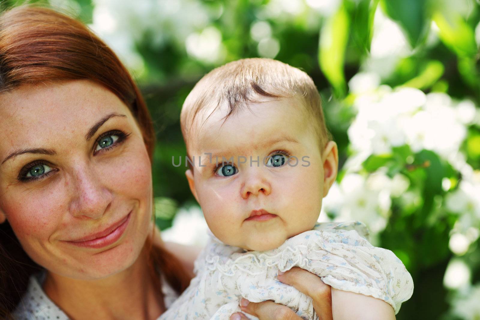 Mother and daughter close up portrait on flower background