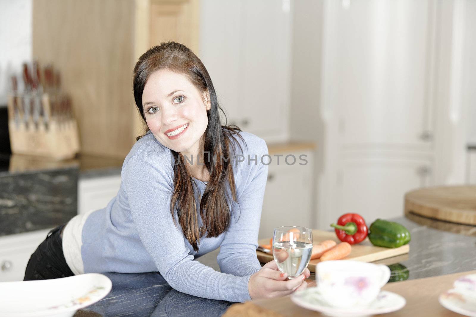 Woman preparing a meal in the kitchen by studiofi