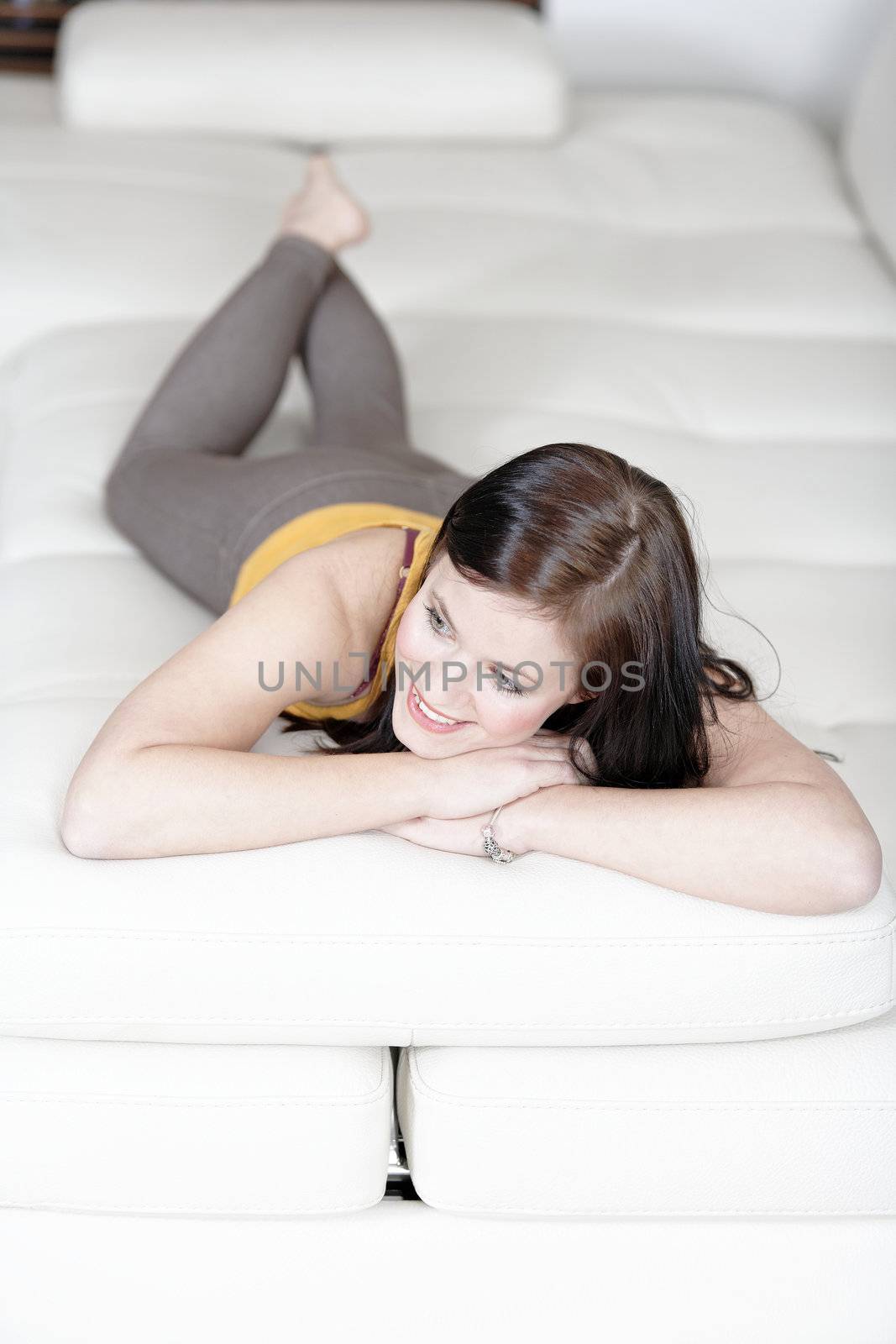 Attractive young woman relaxing on her sofa at home