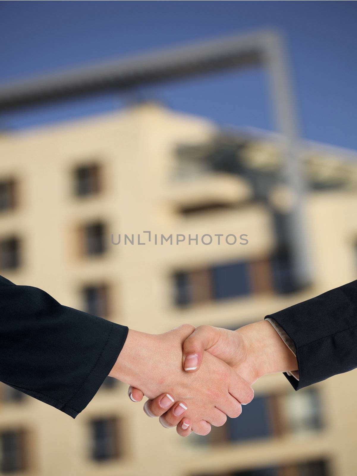 Architectural Handshaking in front of building by adamr