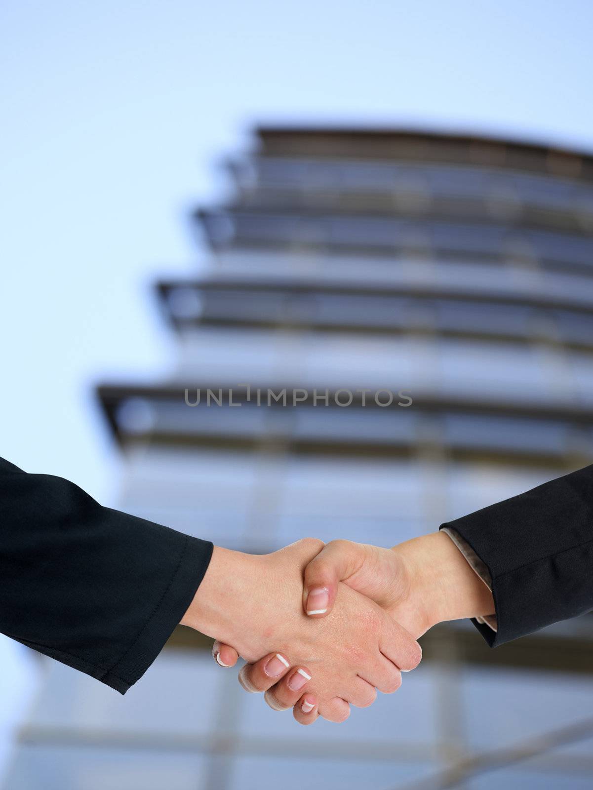 Architectural Handshaking in front of building by adamr