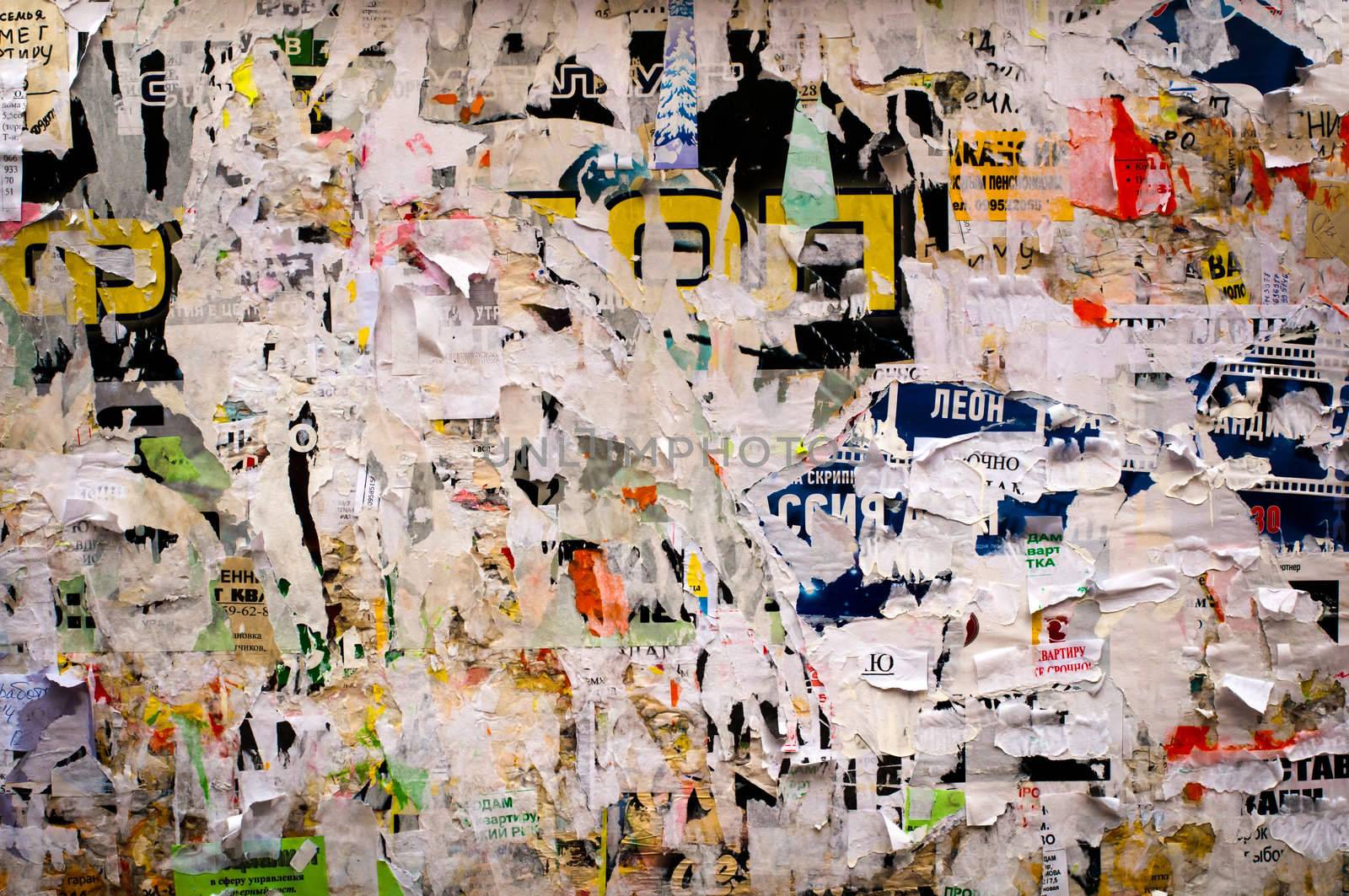 Grungy billboard covered with staples and the remains of paper sign