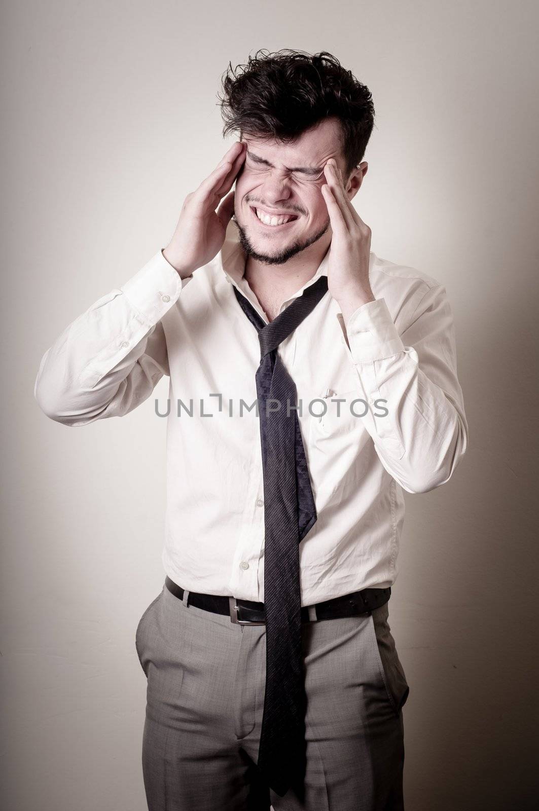 stressed businessman on gray background