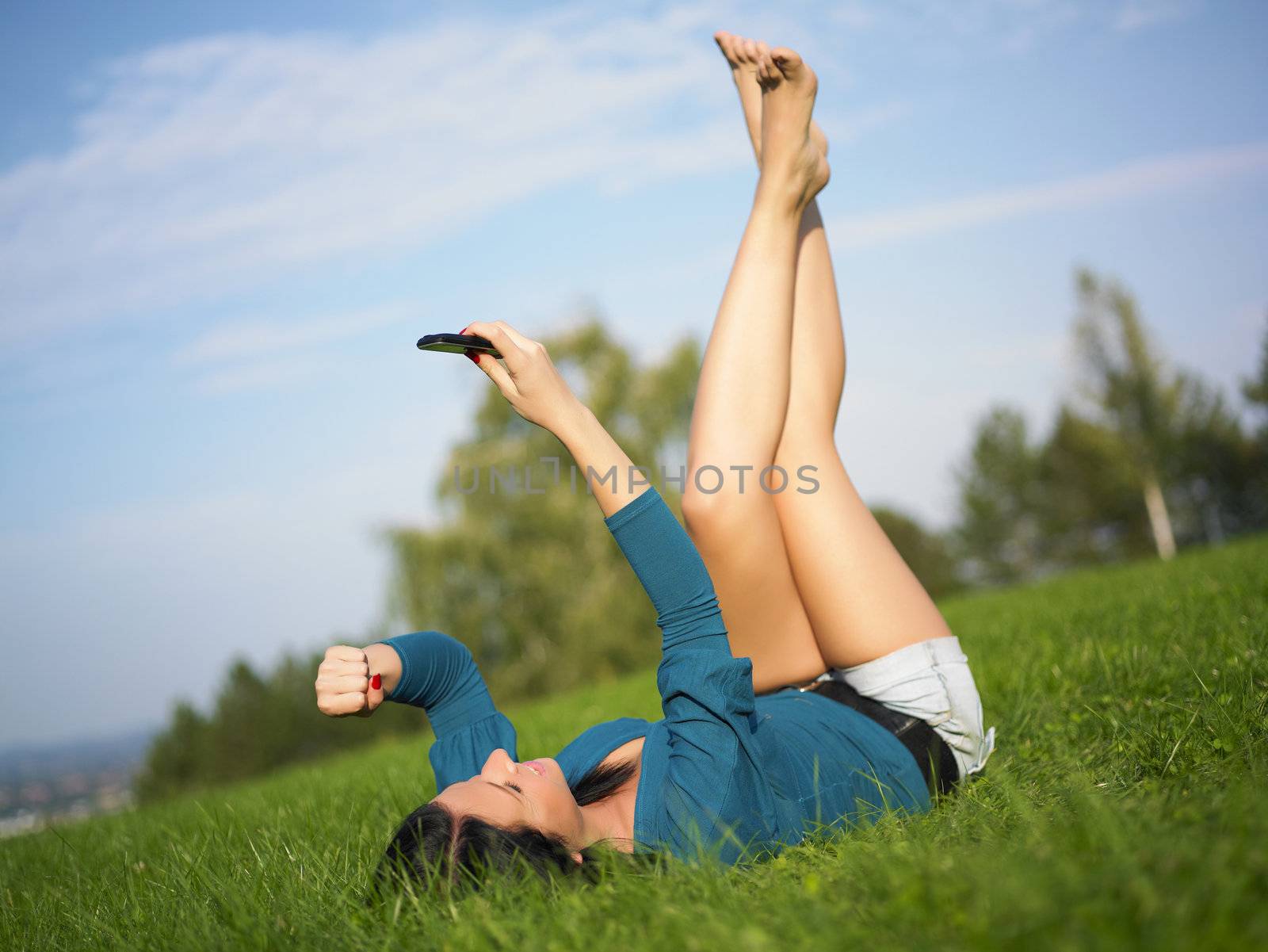 Young woman using mobile phone in park