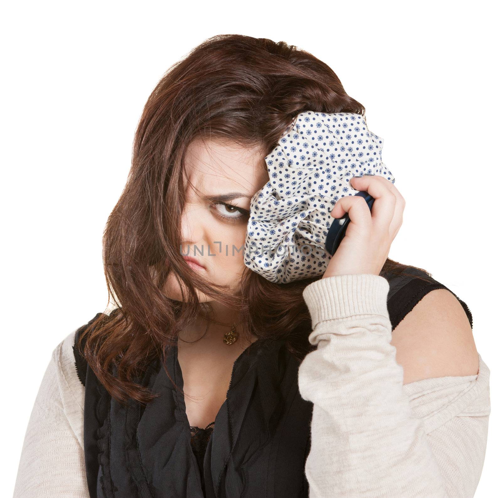 Pouting young lady with ice pack on head