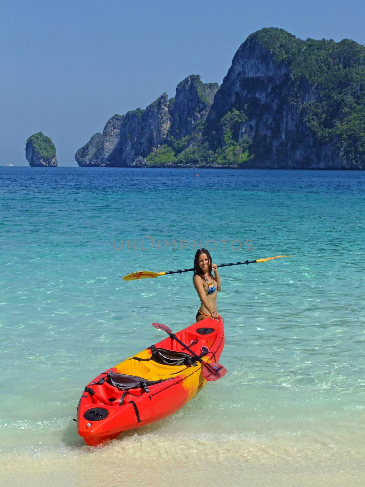 Young woman in bikini with kayak, Phi Phi don island, Thailand by donya_nedomam