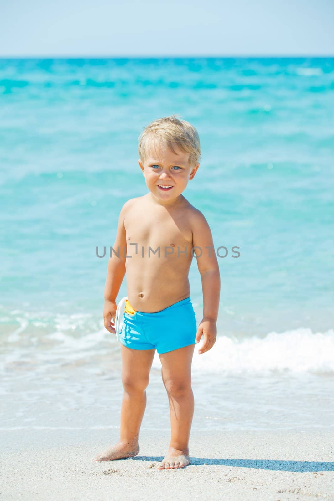 A cute little boy having fun on the exotic beach